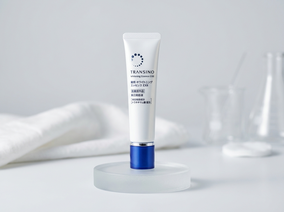 Transino Whitening Essence EXII: pharmaceutical-grade white squeeze tube with royal blue cap and m-tranexamic acid